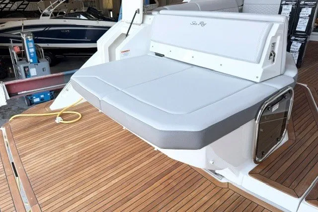 Slide: The Image of 2027 Sea Ray Sundancer 320 boat with sleek seating on a wooden deck. - 6