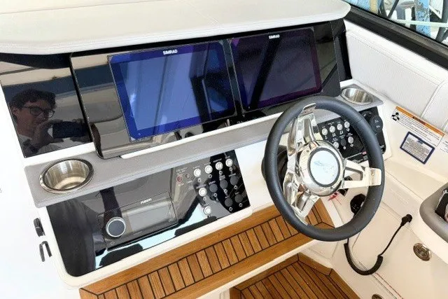 Slide: The Image of 2027 Sea Ray Sundancer 320 helm with dual displays and modern controls. - 9
