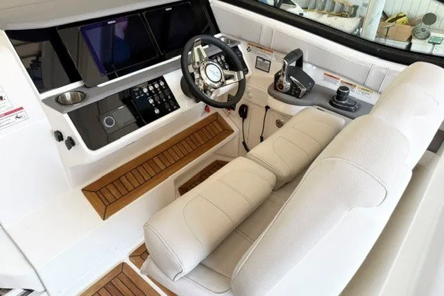 Slide: The Image of 2027 Sea Ray Sundancer 320 helm with modern controls and luxurious seating. - 10
