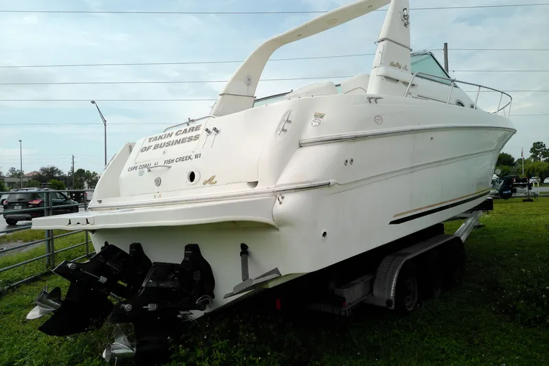 Slide: The Image of 1998 Sea Ray Sundancer 310 boat on trailer, rear view, with "Takin Care of Business" text. - 3