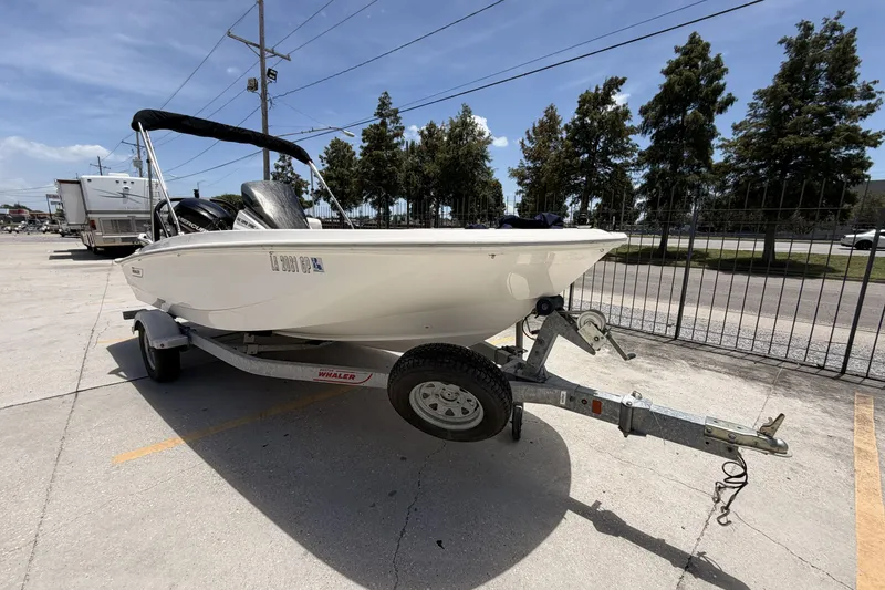 Slide: The Image of 2022 Boston Whaler 160 Super Sport boat on trailer in parking lot. - 3