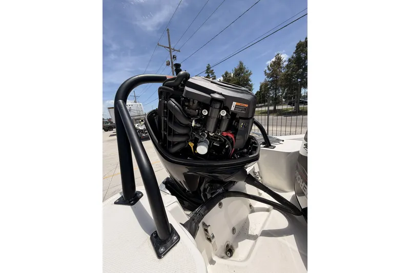 Slide: The Image of 2022 Boston Whaler 160 Super Sport boat engine, detailed view under clear sky. - 9