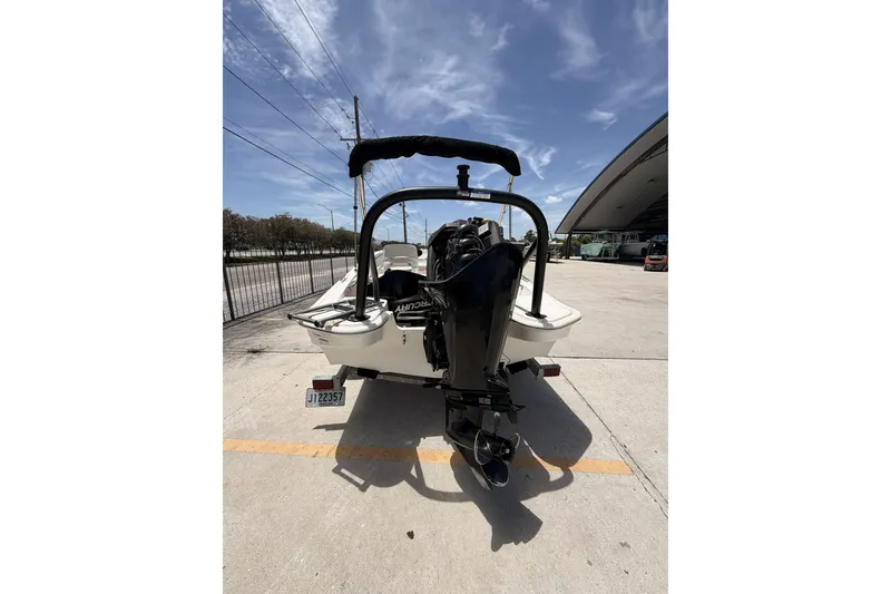 Slide: The Image of 2022 Boston Whaler 160 Super Sport boat with outboard motor, parked outdoors. - 8