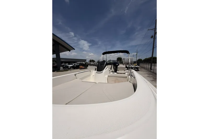 Slide: The Image of 2022 Boston Whaler 160 Super Sport boat with spacious seating and sleek design under a clear sky. - 12