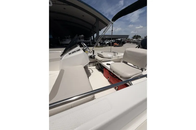 Slide: The Image of 2022 Boston Whaler 160 Super Sport boat interior with seating and console. - 13