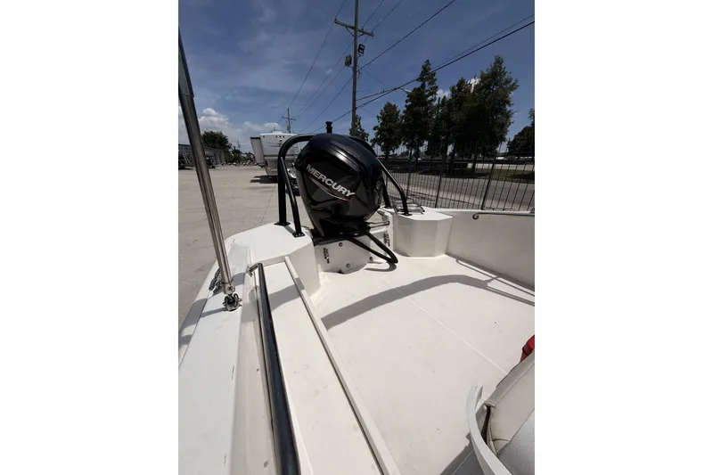Slide: The Image of 2022 Boston Whaler 160 Super Sport boat with Mercury engine, docked outdoors. - 7