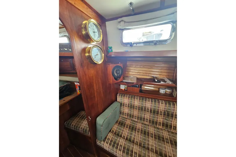 Slide: The Image of Interior of a 1997 Valiant 42 sailboat with wood paneling and nautical instruments. - 10