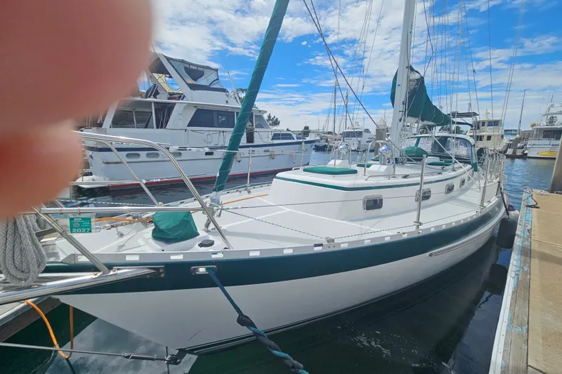 Slide: The Image of Sailboat Valiant 42, 1997 model, docked at marina under blue sky. - 2