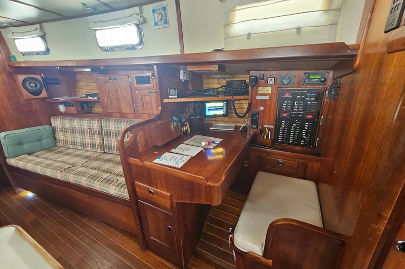 Slide: The Image of Interior of a 1997 Valiant 42 sailboat with navigation station and seating area. - 13