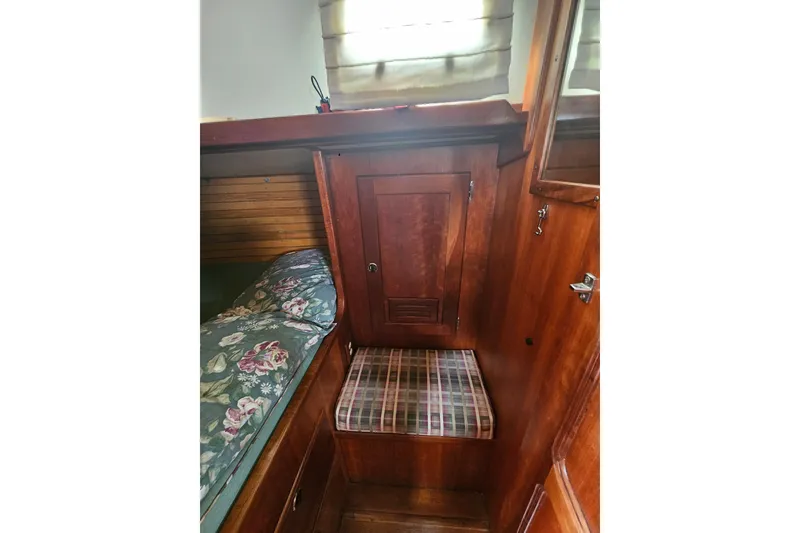 Slide: The Image of Cozy cabin interior of 1997 Valiant 42 sailboat with wooden finish and floral bedding. - 11