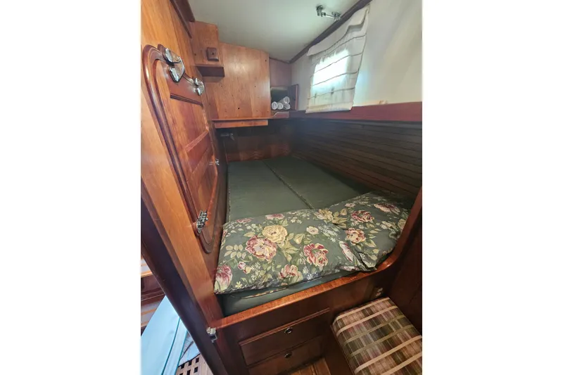 Slide: The Image of Cozy cabin interior of 1997 Valiant 42 sailboat with floral bedding and wooden finish. - 12