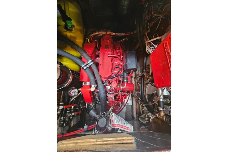 Slide: The Image of Engine compartment of a 1997 Valiant 42, featuring a red engine and various components. - 15