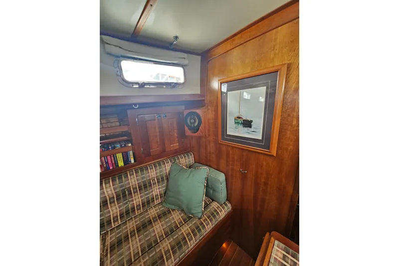 Slide: The Image of Interior of 1997 Valiant 42 sailboat with wood paneling and plaid seating. - 9