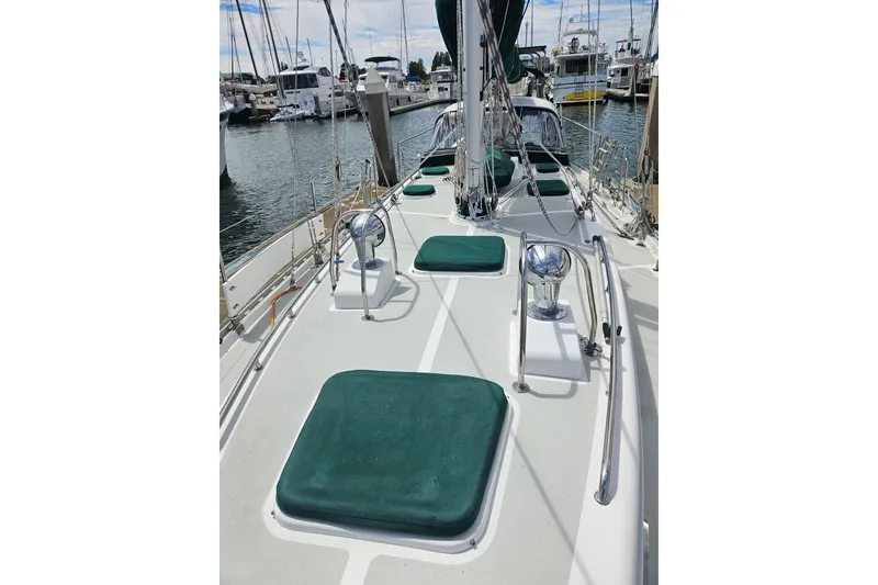 Slide: The Image of Deck view of a 1997 Valiant 42 sailboat docked at a marina. - 19