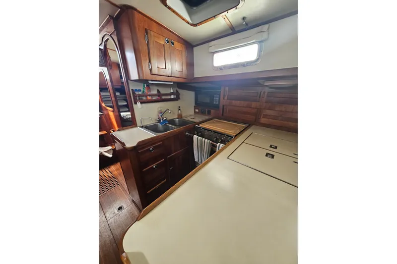 Slide: The Image of Cozy wooden kitchen interior of 1997 Valiant 42 yacht with sink and storage. - 7