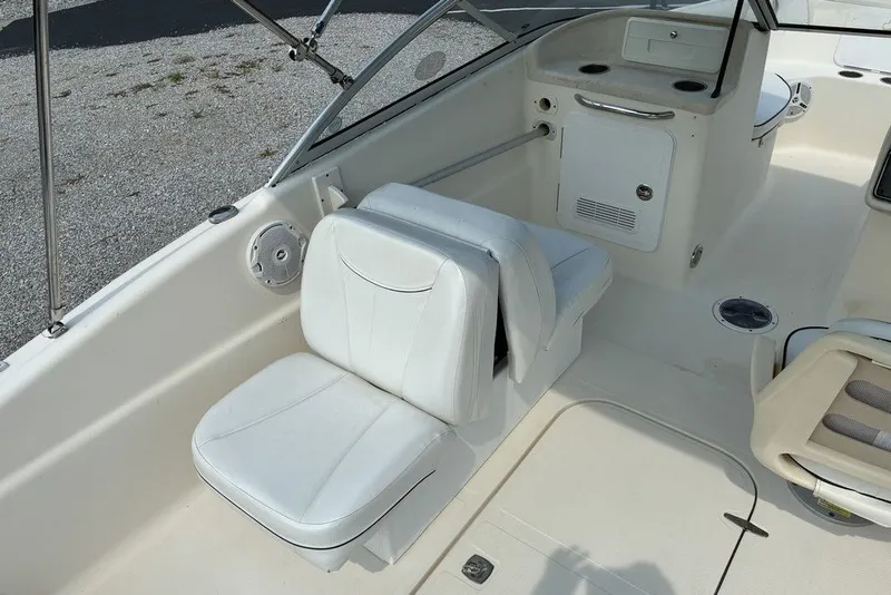 Slide: The Image of 2010 Scout 187 Dorado boat interior with white seating and storage compartments. - 6