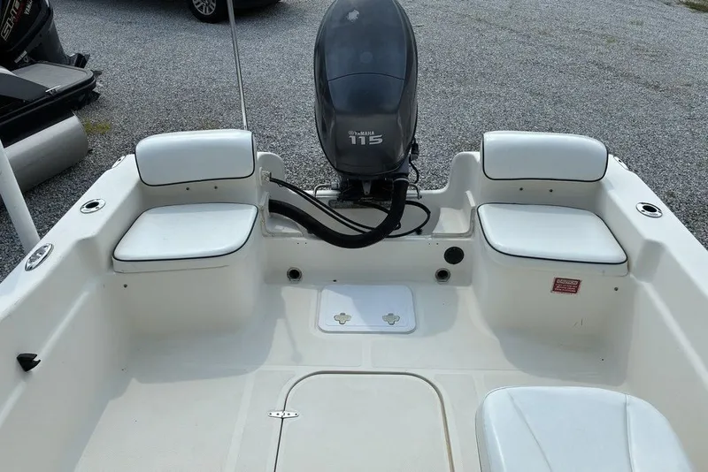 Slide: The Image of 2010 Scout 187 Dorado boat interior with Yamaha 115 engine, featuring white seating. - 5