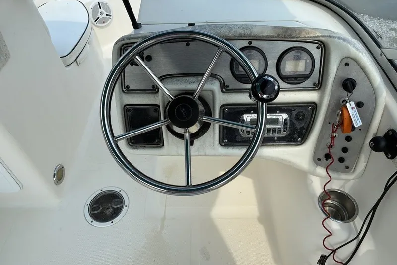 Slide: The Image of Steering console of a 2010 Scout 187 Dorado boat with gauges and controls. - 7