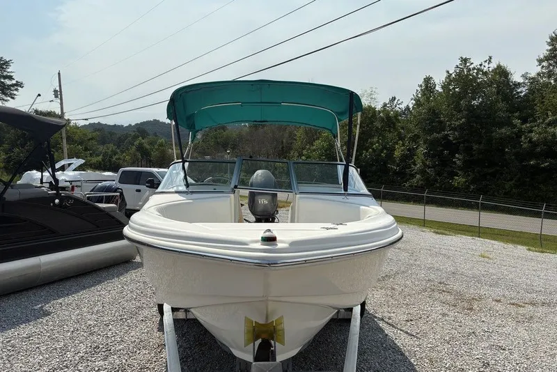 Slide: The Image of 2010 Scout 187 Dorado boat with green canopy on gravel lot. - 3