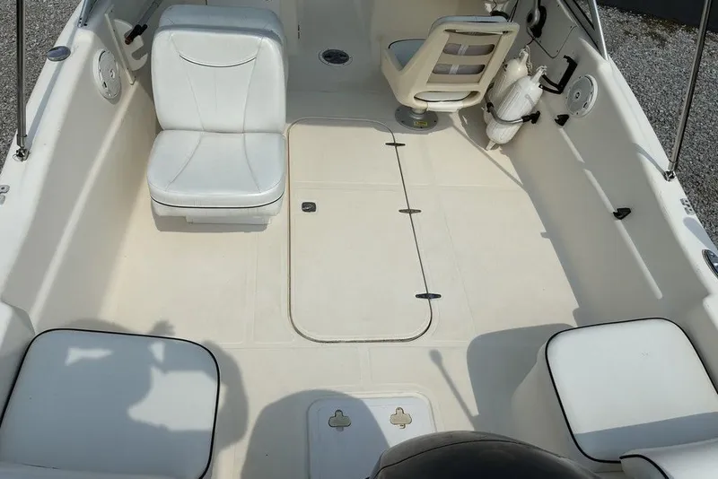 Slide: The Image of 2010 Scout 187 Dorado boat interior with white seating and spacious deck layout. - 8