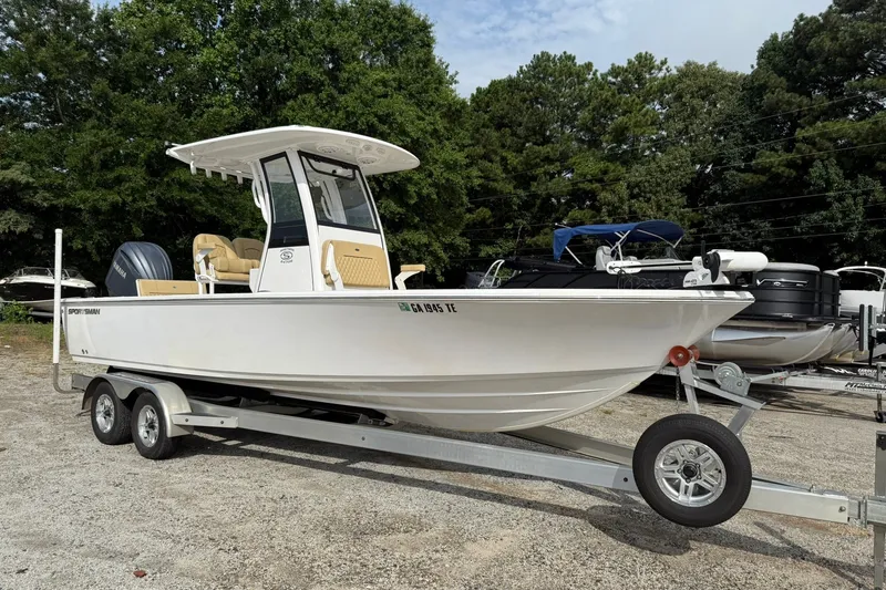 Slide: The Image of 2022 Sportsman Masters 247OE Bay Boat on trailer, parked outdoors. - 2