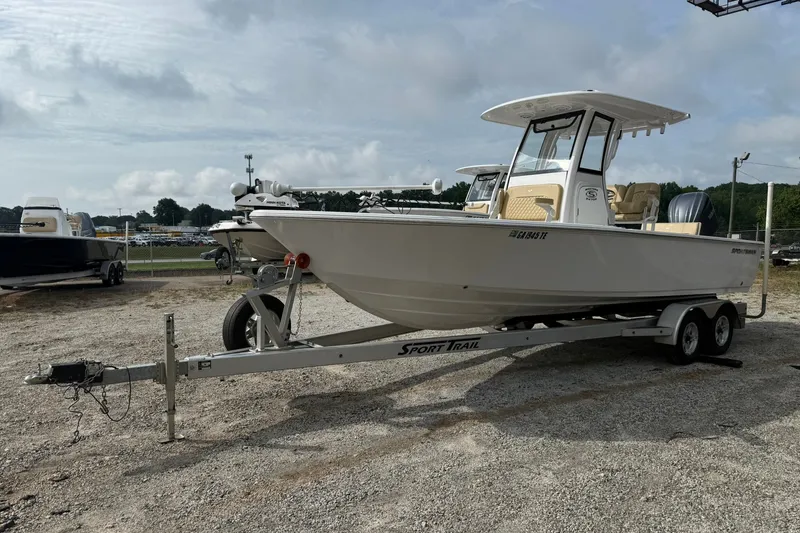 Slide: The Image of 2022 Sportsman Masters 247OE Bay Boat on trailer, parked outdoors under cloudy sky. - 1