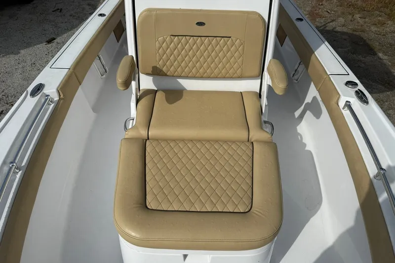 Slide: The Image of 2022 Sportsman Masters 247OE Bay Boat with tan quilted seating in the bow area. - 9