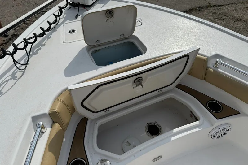 Slide: The Image of 2022 Sportsman Masters 247OE Bay Boat with open storage compartments on deck. - 10