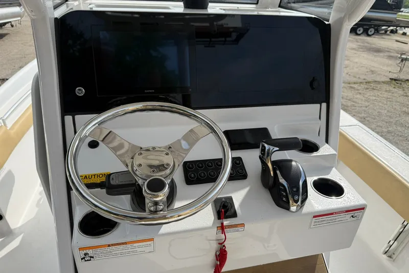 Slide: The Image of Helm of 2022 Sportsman Masters 247OE Bay Boat with steering wheel and controls. - 7