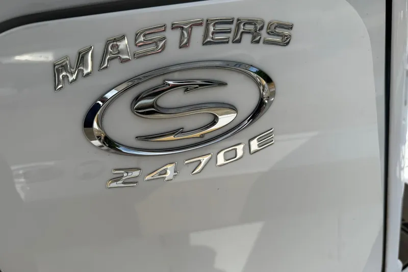 Slide: The Image of 2022 Sportsman Masters 247OE Bay Boat emblem on white surface. - 11