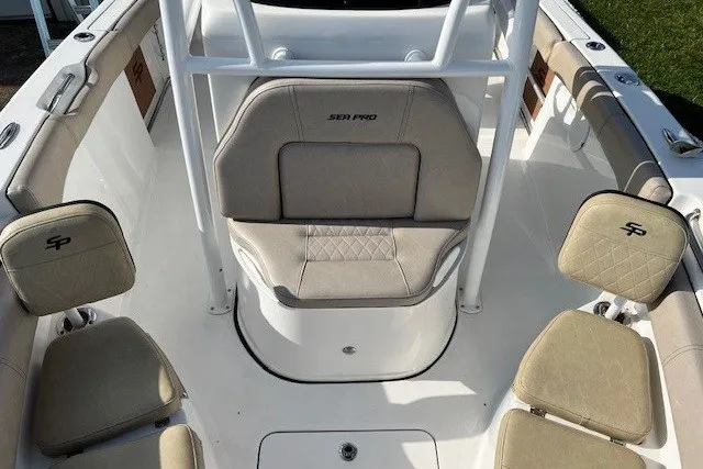 Slide: The Image of 2021 Sea Pro 219 Center Console boat interior with beige seating and white framework. - 15