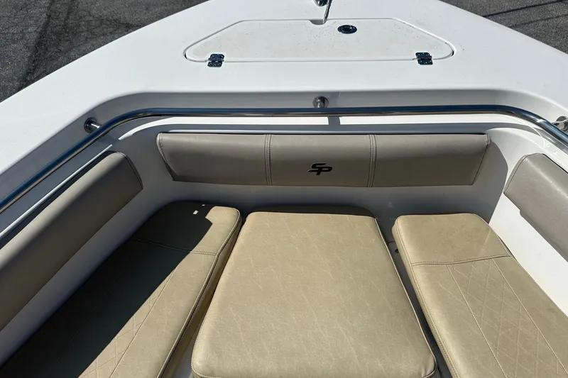 Slide: The Image of 2021 Sea Pro 219 Center Console boat interior with cushioned seating and storage. - 35
