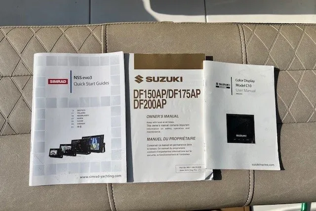 Slide: The Image of Manuals for Simrad NSS evo3, Suzuki DF150AP/DF175AP/DF200AP, and Suzuki Color Display on boat seat. - 17
