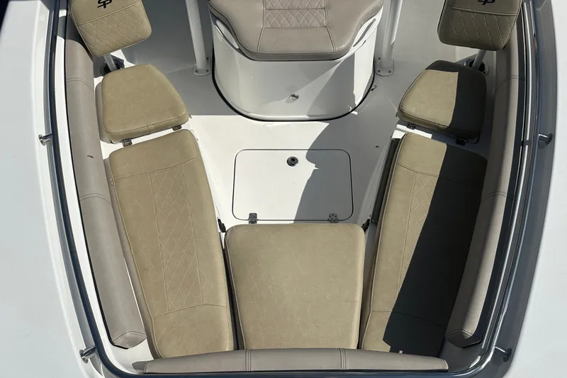 Slide: The Image of 2021 Sea Pro 219 Center Console boat interior with beige seating and storage compartment. - 34
