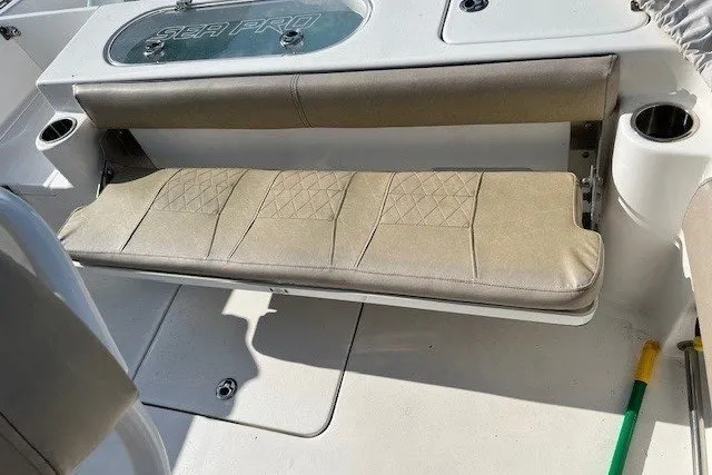 Slide: The Image of The 2021 Sea Pro 219 Center Console features a beige fold-down bench with storage underneath. - 7