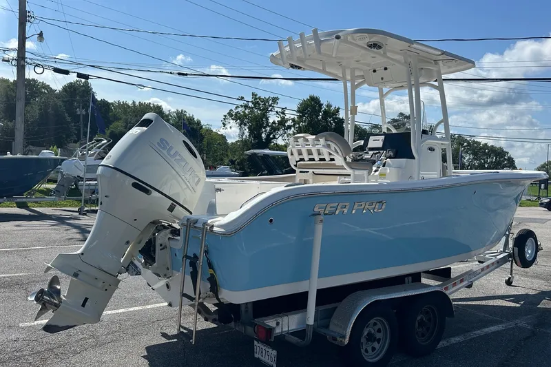 Slide: The Image of 2021 Sea Pro 219 Center Console boat with Suzuki outboard motor on trailer. - 2