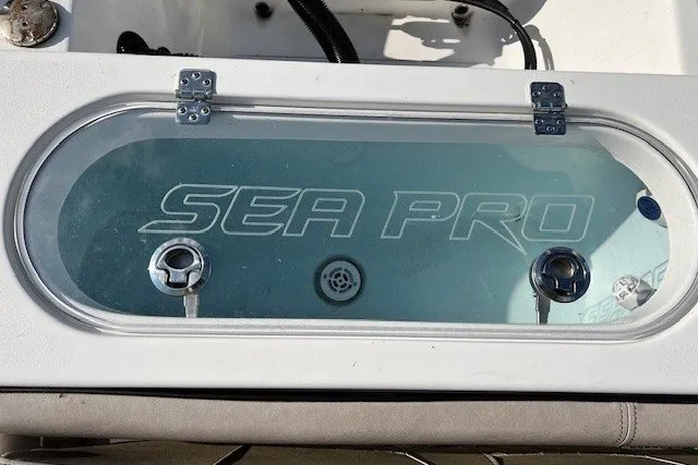 Slide: The Image of Livewell on 2021 Sea Pro 219 Center Console boat, featuring clear lid and branding. - 6