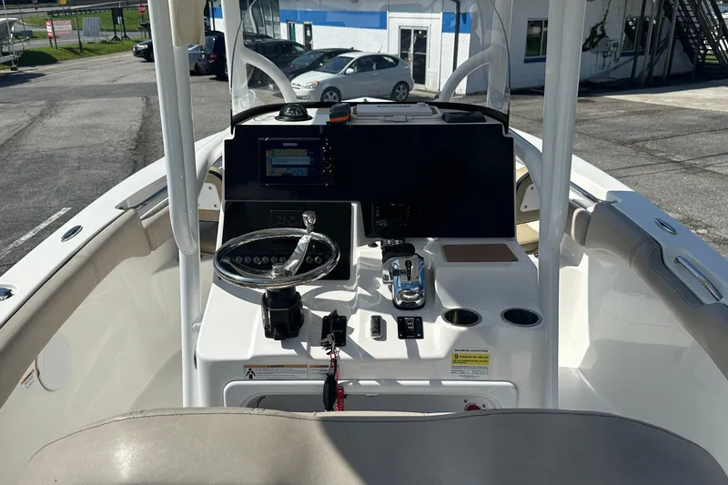 Slide: The Image of 2021 Sea Pro 219 Center Console boat interior with steering wheel and navigation system. - 26