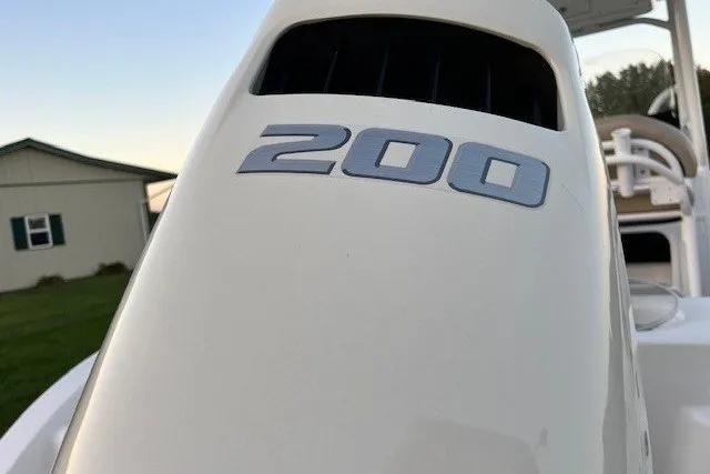 Slide: The Image of 2021 Sea Pro 219 Center Console boat engine with "200" marking, outdoor setting. - 3