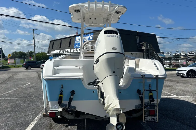 Slide: The Image of 2021 Sea Pro 219 Center Console boat with powerful outboard motor in a parking lot. - 3