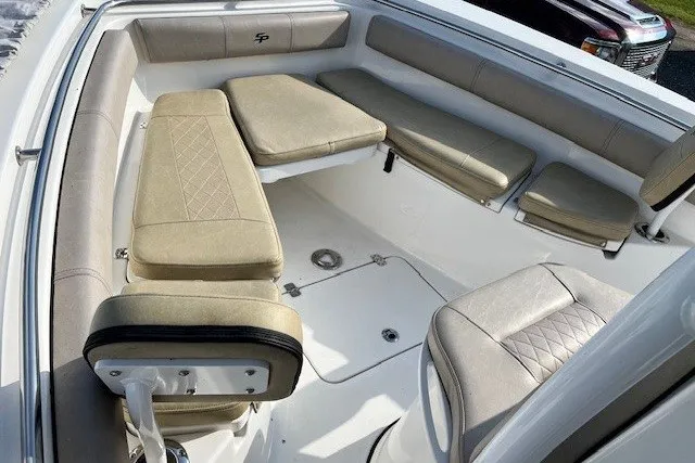 Slide: The Image of 2021 Sea Pro 219 Center Console boat interior with cushioned seating and storage. - 14