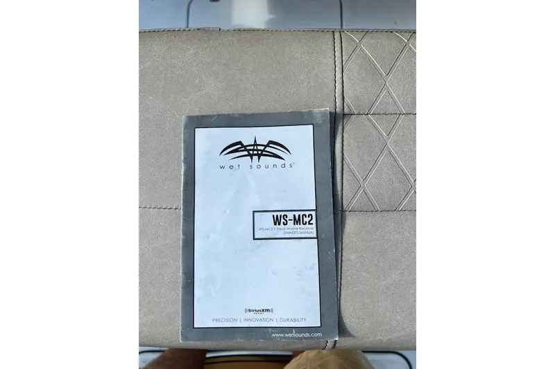 Slide: The Image of Wet Sounds WS-MC2 manual on Sea Pro 219 Center Console boat seat. - 18