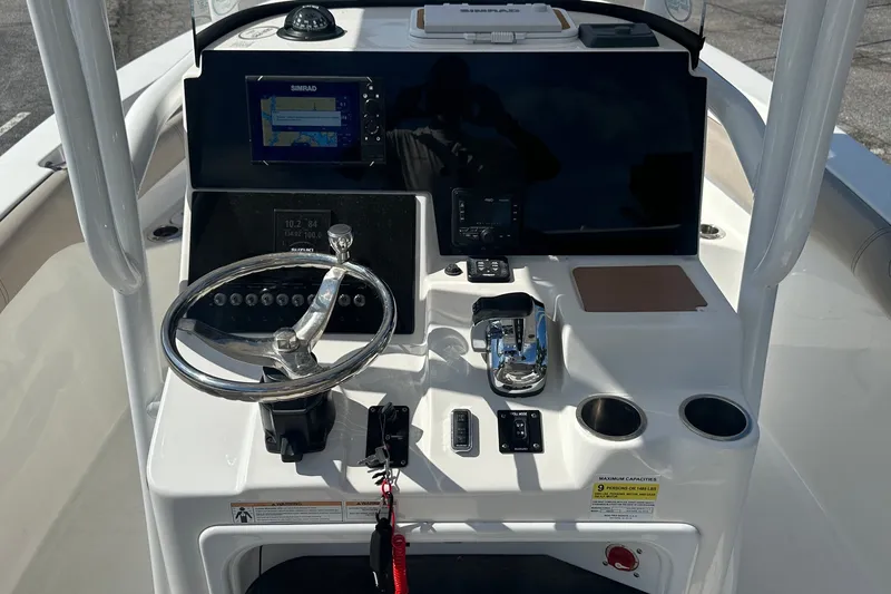 Slide: The Image of 2021 Sea Pro 219 Center Console boat dashboard with steering wheel and navigation system. - 25