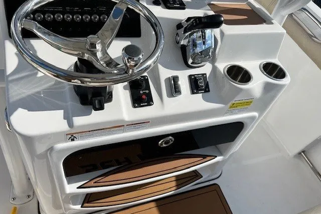 Slide: The Image of 2021 Sea Pro 219 Center Console boat helm with steering wheel and controls. - 11