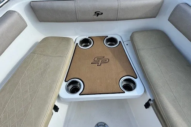 Slide: The Image of 2021 Sea Pro 219 Center Console boat interior with seating and cup holders. - 16