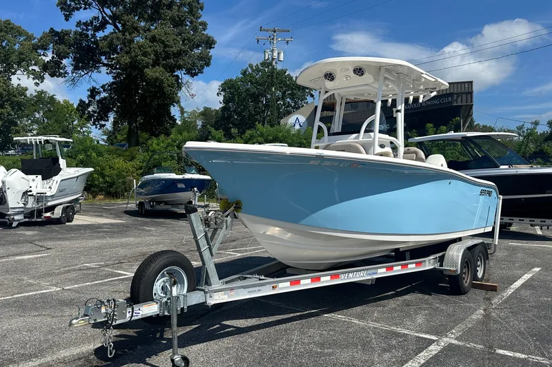 Slide: The Image of 2021 Sea Pro 219 Center Console boat on trailer in parking lot. - 1