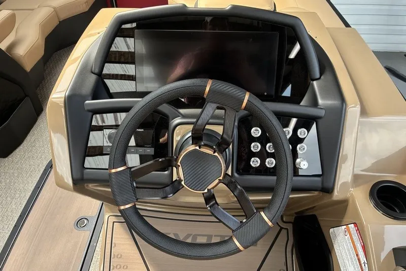 Slide: The Image of Steering wheel and dashboard of 2027 Evotti 723CS boat, featuring modern controls and sleek design. - 2
