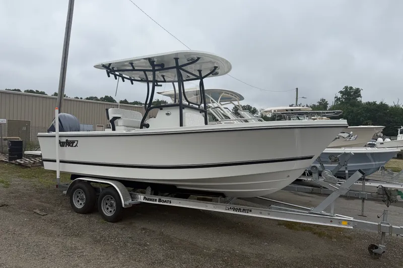 Slide: The Image of 2027 Parker 220 Coastal Elite boat on trailer, parked outdoors, overcast sky. - 3
