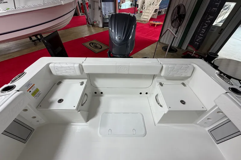 Slide: The Image of 2027 Parker 220 Coastal Elite boat interior with seating and storage compartments. - 11