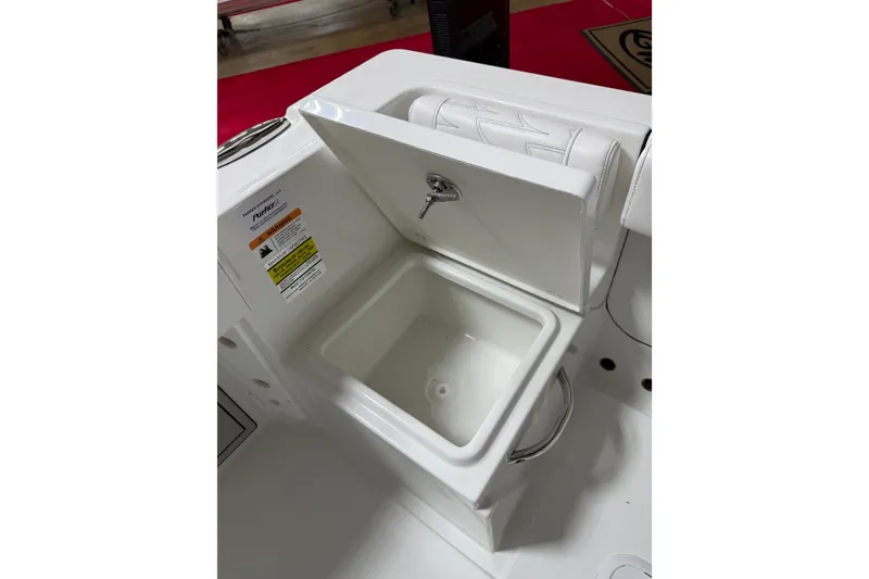 Slide: The Image of Open storage compartment on 2027 Parker 220 Coastal Elite boat, featuring sleek white design. - 15